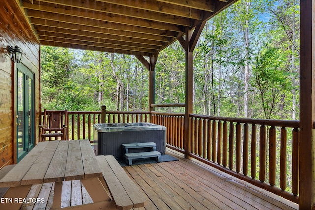 wooden deck featuring a hot tub