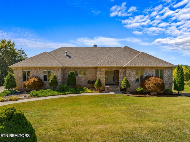 single story home featuring a front lawn