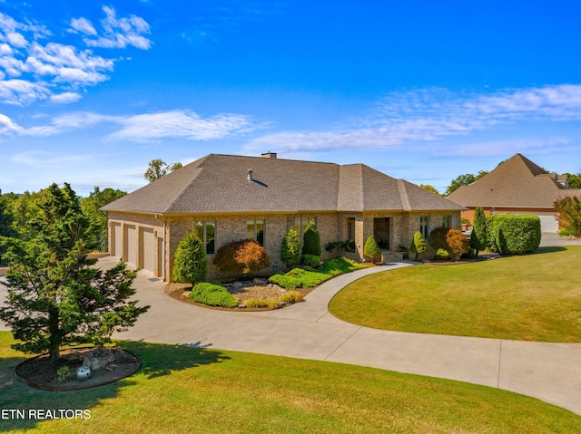 view of front of home featuring a garage and a front lawn