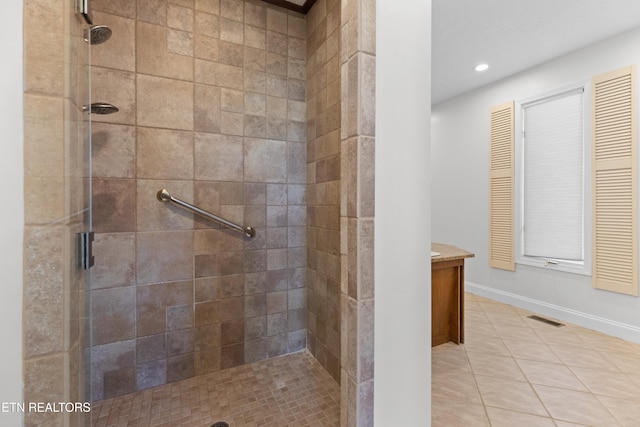 bathroom featuring tile patterned flooring and a shower with shower door