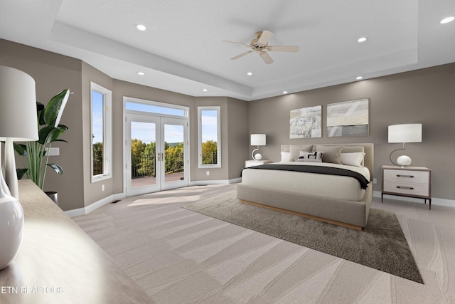 carpeted bedroom featuring ceiling fan, access to outside, french doors, and a raised ceiling