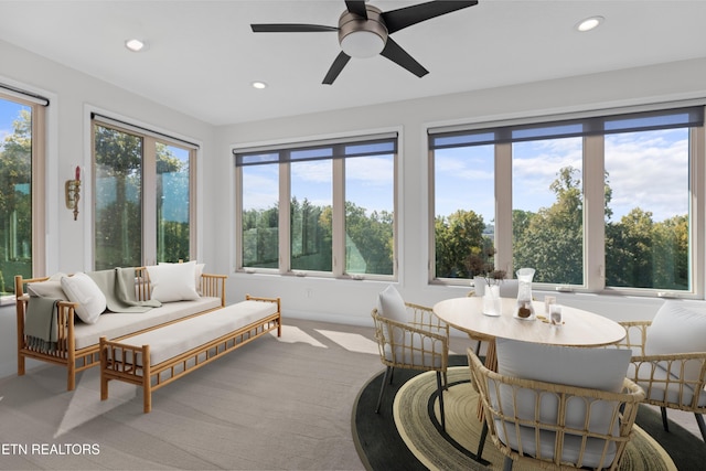 sunroom / solarium featuring ceiling fan