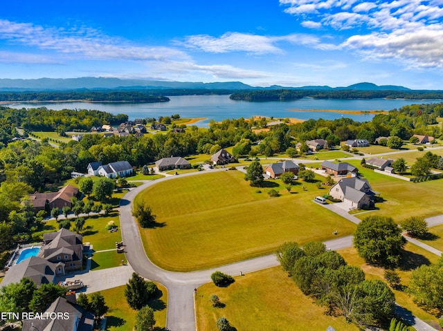 drone / aerial view featuring a water and mountain view