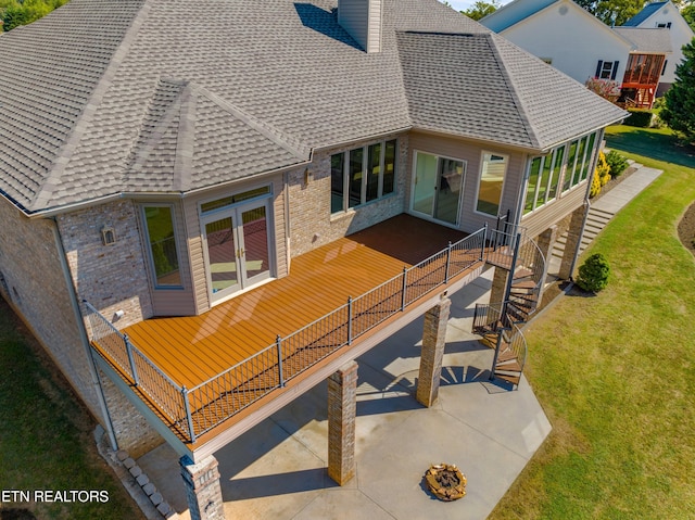 rear view of house featuring a patio and a lawn