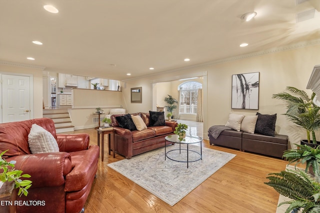 living area featuring light wood-style floors, recessed lighting, and crown molding