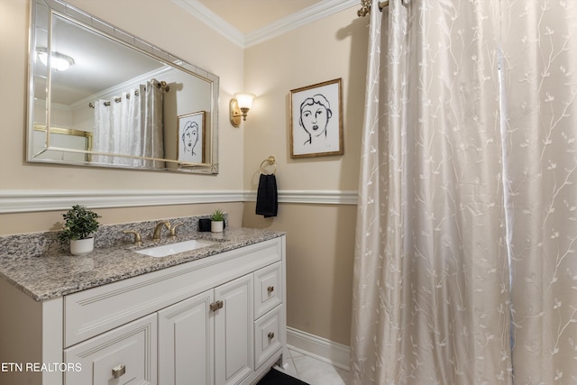 full bathroom featuring baseboards, crown molding, and vanity