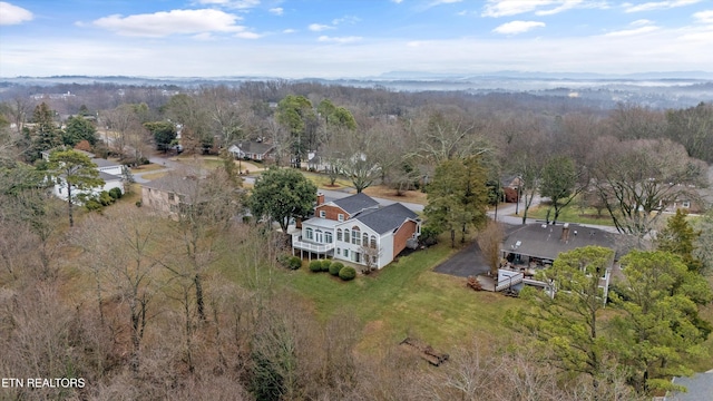 bird's eye view with a wooded view