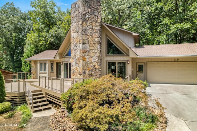 view of front of property with a garage and a deck