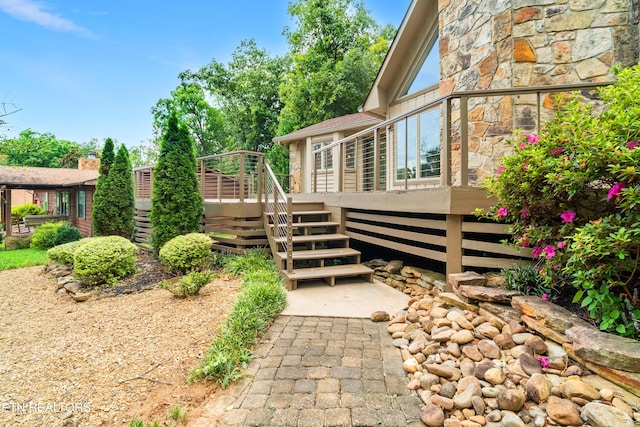 view of property exterior featuring a wooden deck