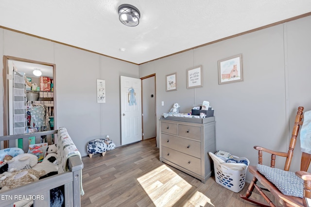 bedroom featuring hardwood / wood-style floors and crown molding