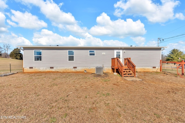 back of house featuring a yard and central AC unit