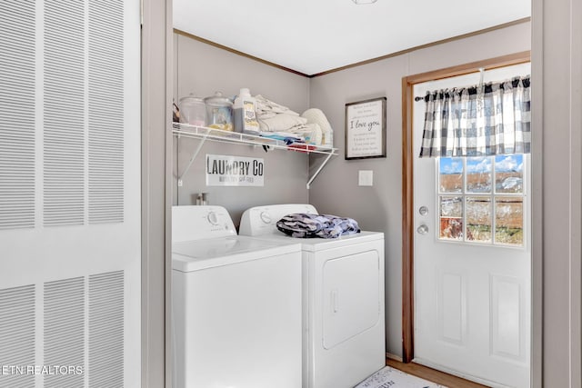 clothes washing area with ornamental molding and independent washer and dryer