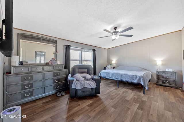 bedroom featuring crown molding, dark hardwood / wood-style floors, and a textured ceiling