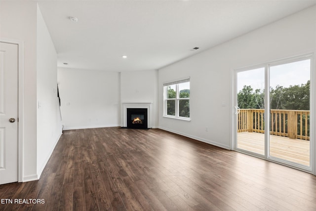 12468 Hatmaker Ln, Knoxville, TN 37932 - unfurnished living room featuring dark wood-type flooring, a fireplace with flush hearth, recessed lighting, and baseboards