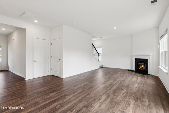 12468 Hatmaker Ln, Knoxville, TN 37932 - unfurnished living room with healthy amount of natural light, dark wood-type flooring, a fireplace with flush hearth, and recessed lighting