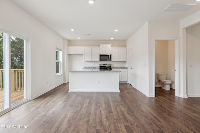 12468 Hatmaker Ln, Knoxville, TN 37932 - kitchen with appliances with stainless steel finishes, dark wood-type flooring, white cabinets, recessed lighting, and a kitchen island with sink