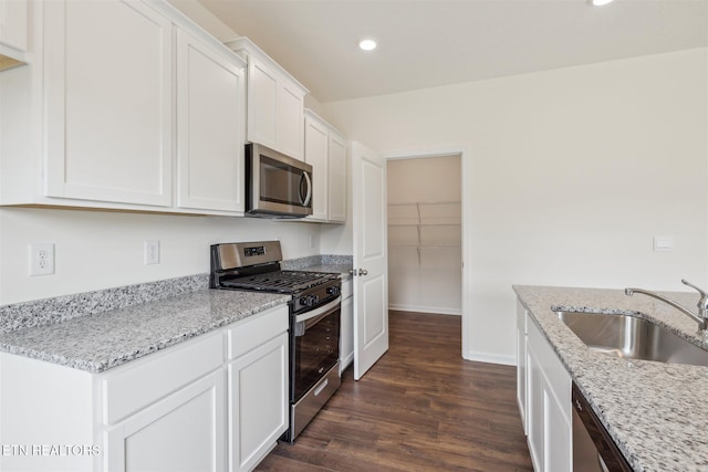 12468 Hatmaker Ln, Knoxville, TN 37932 - kitchen with appliances with stainless steel finishes, a sink, dark wood finished floors, recessed lighting, and white cabinetry