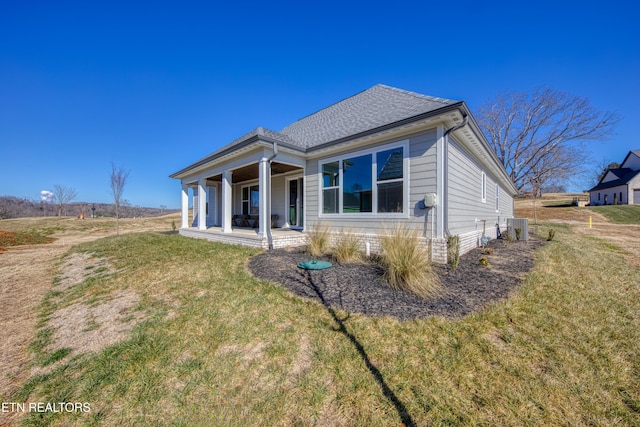 rear view of property featuring central AC, a yard, and a patio area