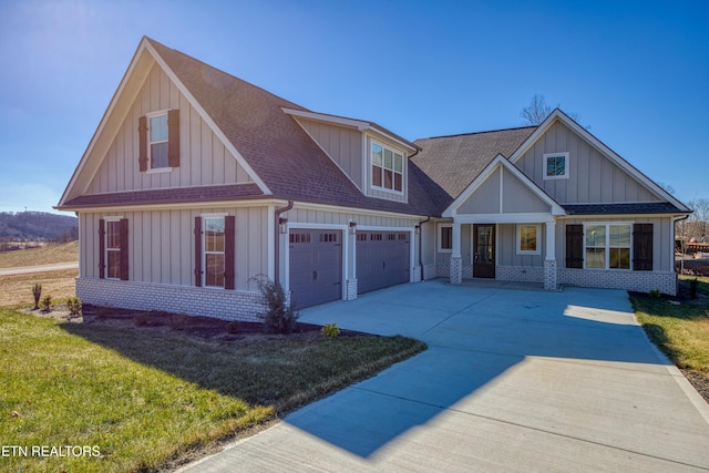 craftsman-style house featuring a garage, a front yard, and covered porch