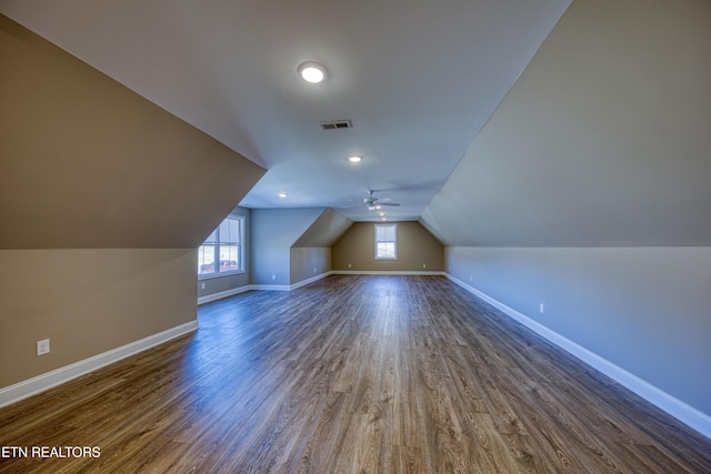 additional living space with dark hardwood / wood-style flooring and lofted ceiling