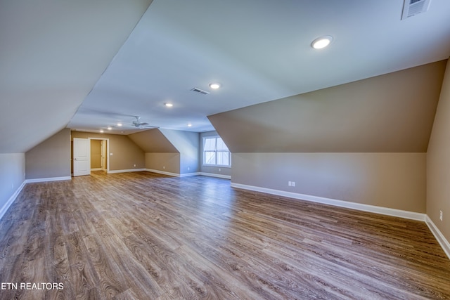 bonus room with lofted ceiling and hardwood / wood-style floors