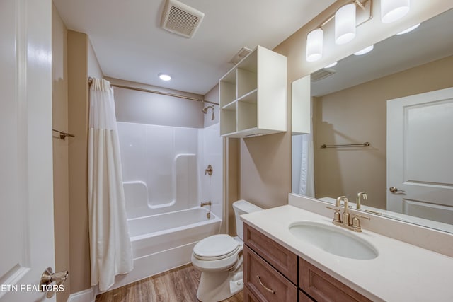 full bathroom with vanity, toilet, hardwood / wood-style floors, and shower / bath combo with shower curtain