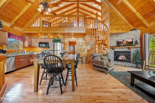 dining room with light hardwood / wood-style flooring, a fireplace, and wooden ceiling