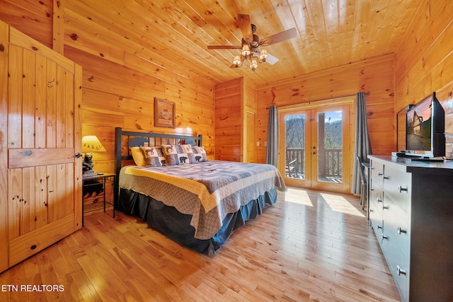 bedroom with wood walls, light hardwood / wood-style flooring, access to outside, wooden ceiling, and french doors