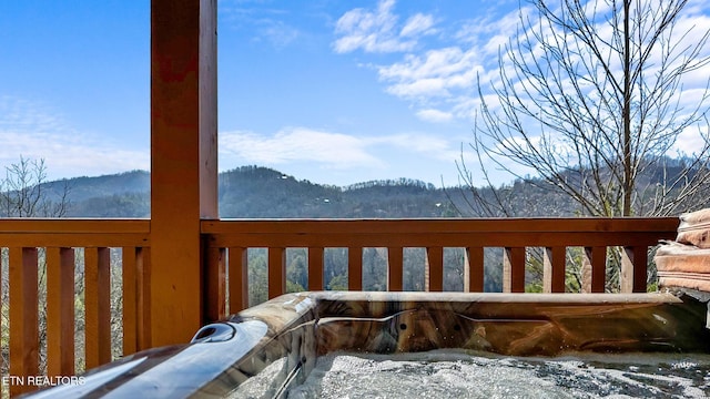 snow covered deck featuring a mountain view