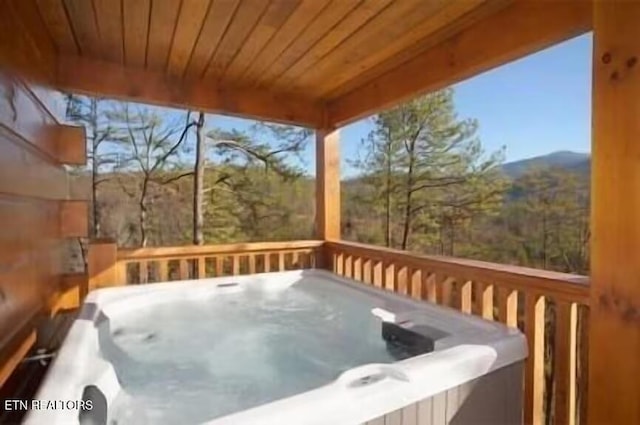 wooden deck featuring a hot tub