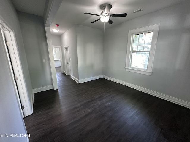 unfurnished room with ceiling fan and dark hardwood / wood-style floors