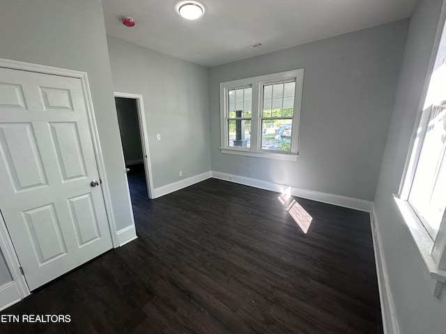 empty room featuring dark hardwood / wood-style flooring