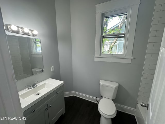 bathroom with vanity, hardwood / wood-style flooring, and toilet