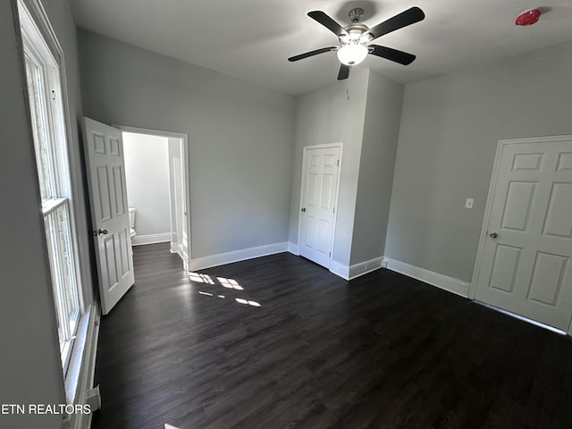 unfurnished bedroom with dark wood-type flooring and ceiling fan