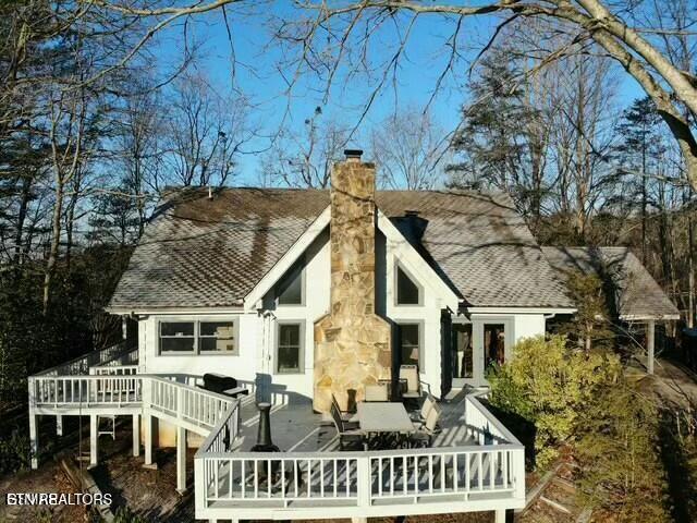 back of house with a wooden deck