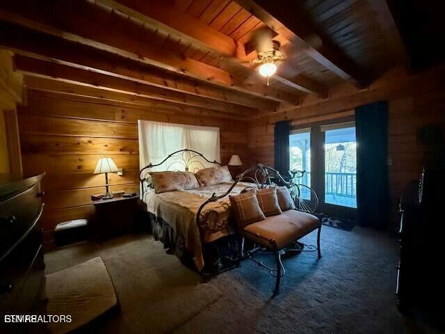 carpeted bedroom with wood ceiling, wooden walls, and beamed ceiling