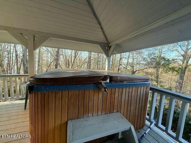 deck with a gazebo and a hot tub