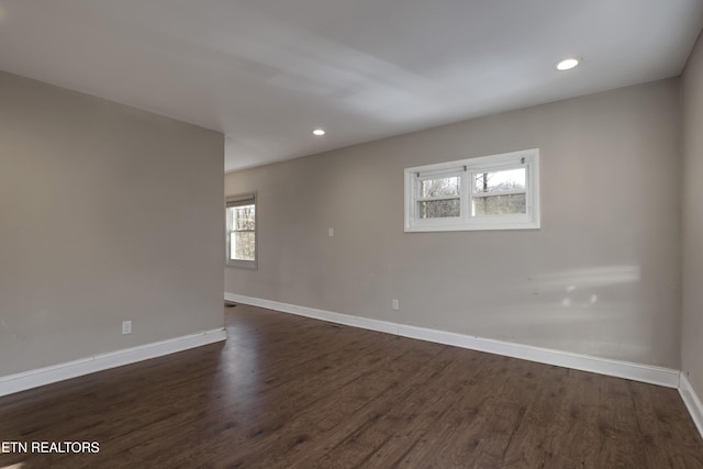 spare room with dark hardwood / wood-style floors