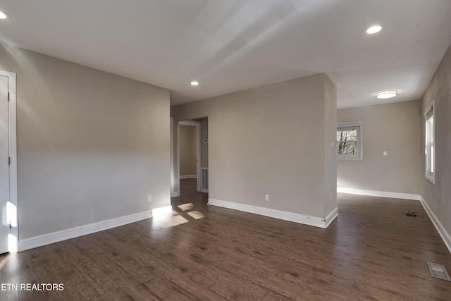 unfurnished room featuring dark wood-type flooring