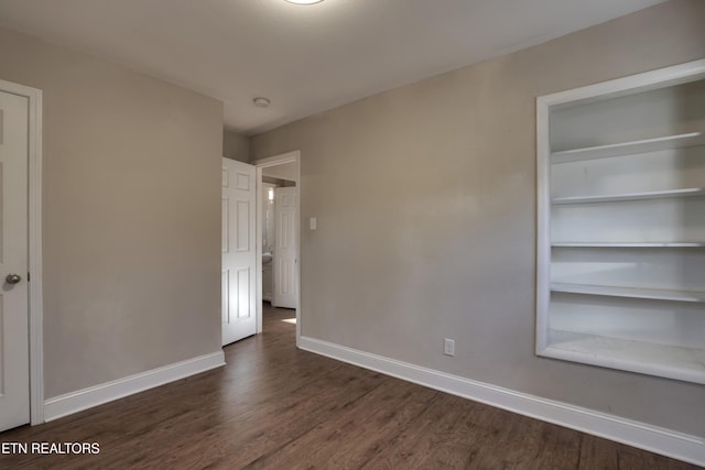 spare room featuring dark hardwood / wood-style flooring