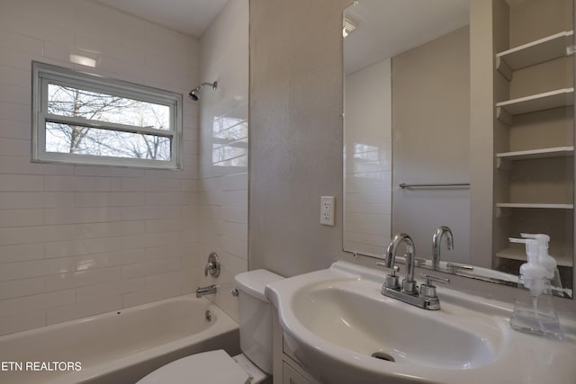 full bathroom featuring tiled shower / bath, vanity, and toilet