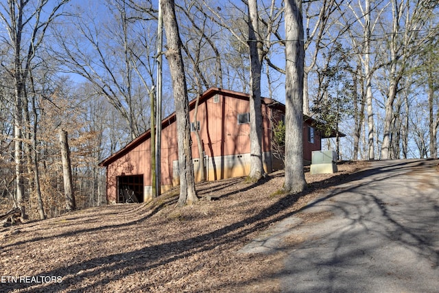 view of side of property featuring an outbuilding