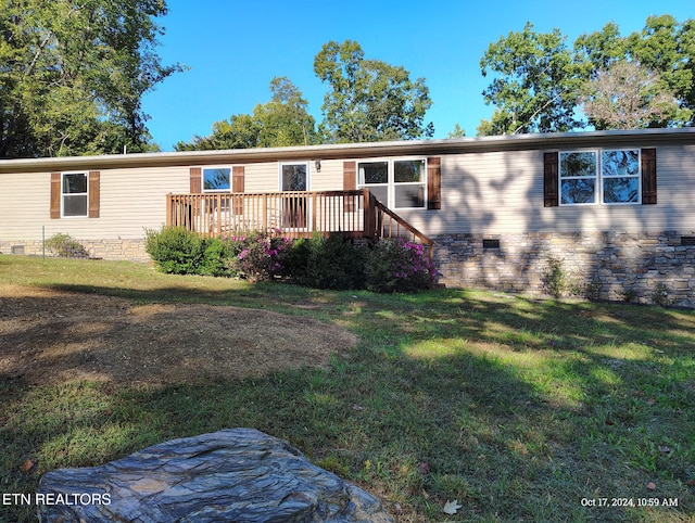 manufactured / mobile home with a front lawn and a deck