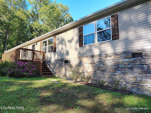 view of side of property with a yard