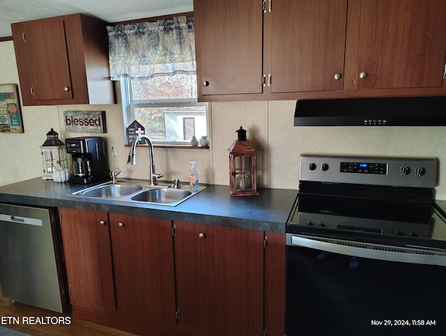 kitchen with stainless steel appliances, extractor fan, sink, and tasteful backsplash