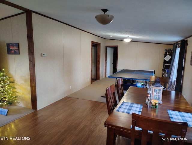 dining space featuring ornamental molding and hardwood / wood-style floors