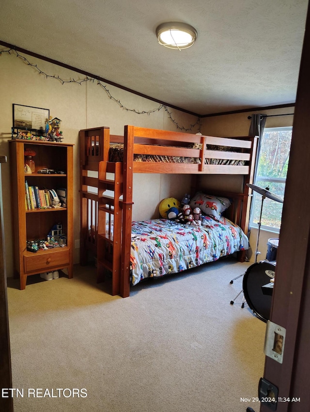 bedroom with a textured ceiling and carpet flooring