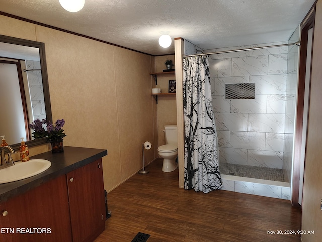 bathroom with hardwood / wood-style flooring, vanity, ornamental molding, toilet, and a shower with curtain