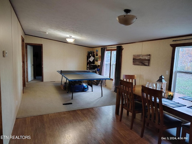 rec room featuring crown molding, hardwood / wood-style floors, and a textured ceiling