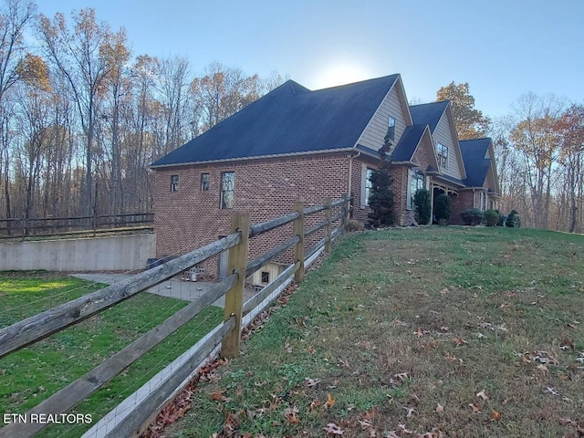 view of property exterior with a lawn